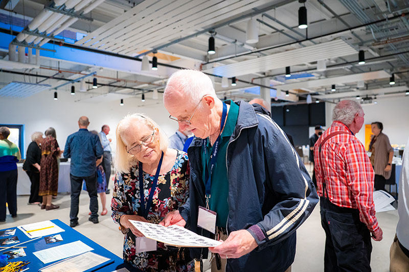 An older couple looking at a booth. 