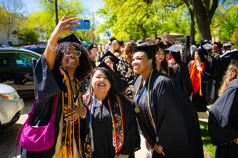 Students taking a selfie together. Links to What to Give