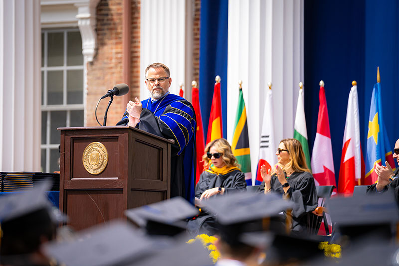 The President of the College giving a speech at graduation. Links to Gifts from Retirement Plans